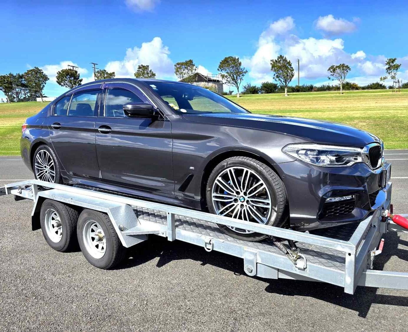bmw sedan being shifted by trailer